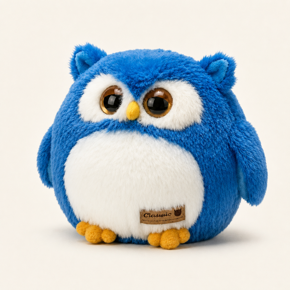 Peluche hibou bleue vue de face sur fond ivoire