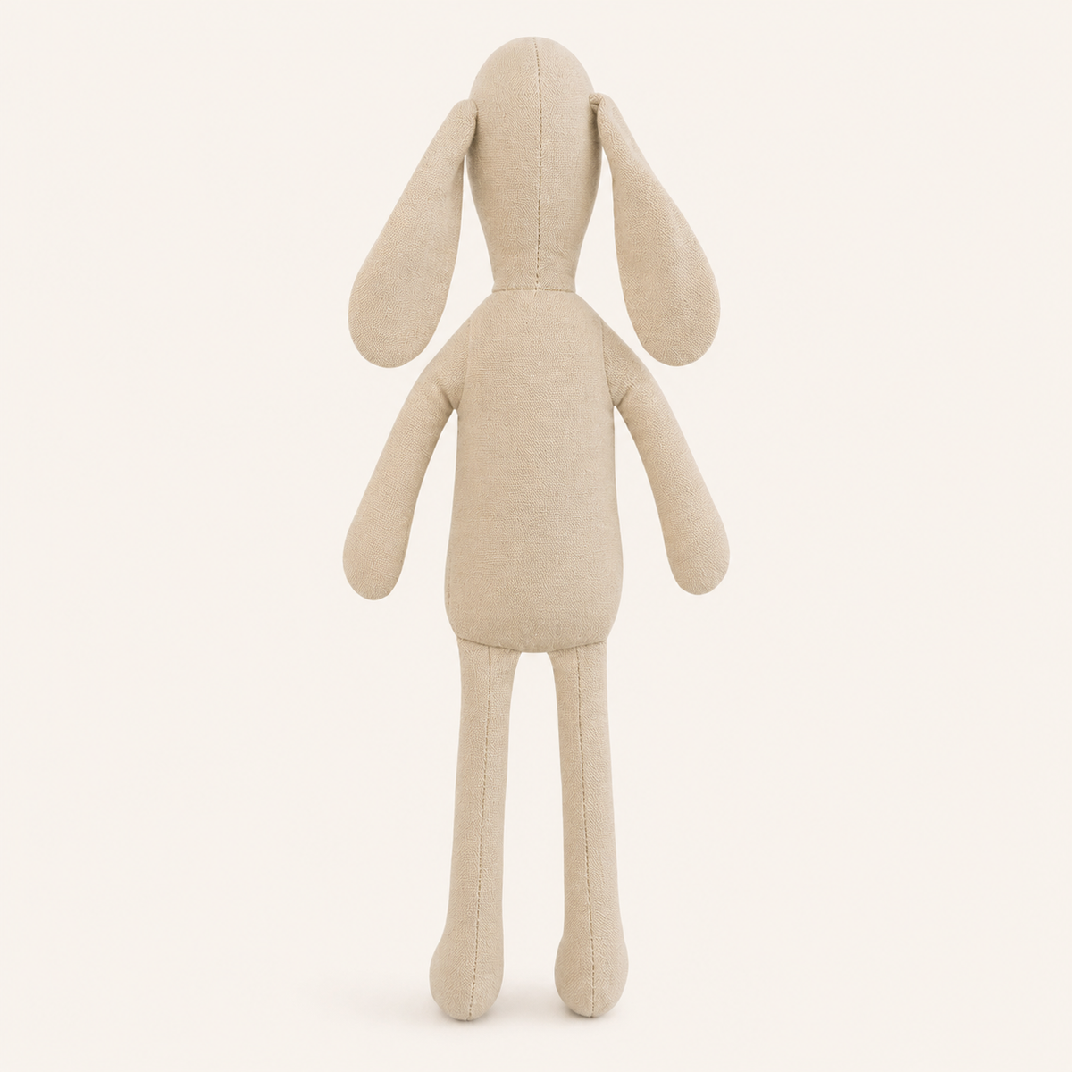 Doudou lapin en tissu beige vu de dos sur fond ivoire