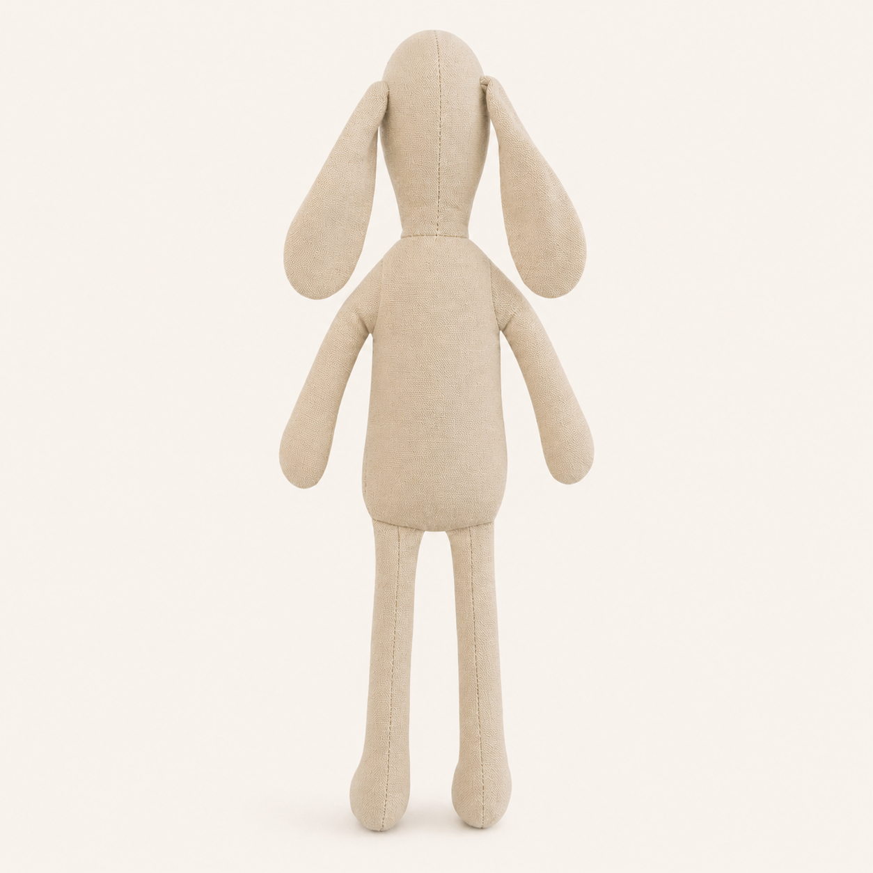 Doudou lapin en tissu beige vu de dos sur fond ivoire
