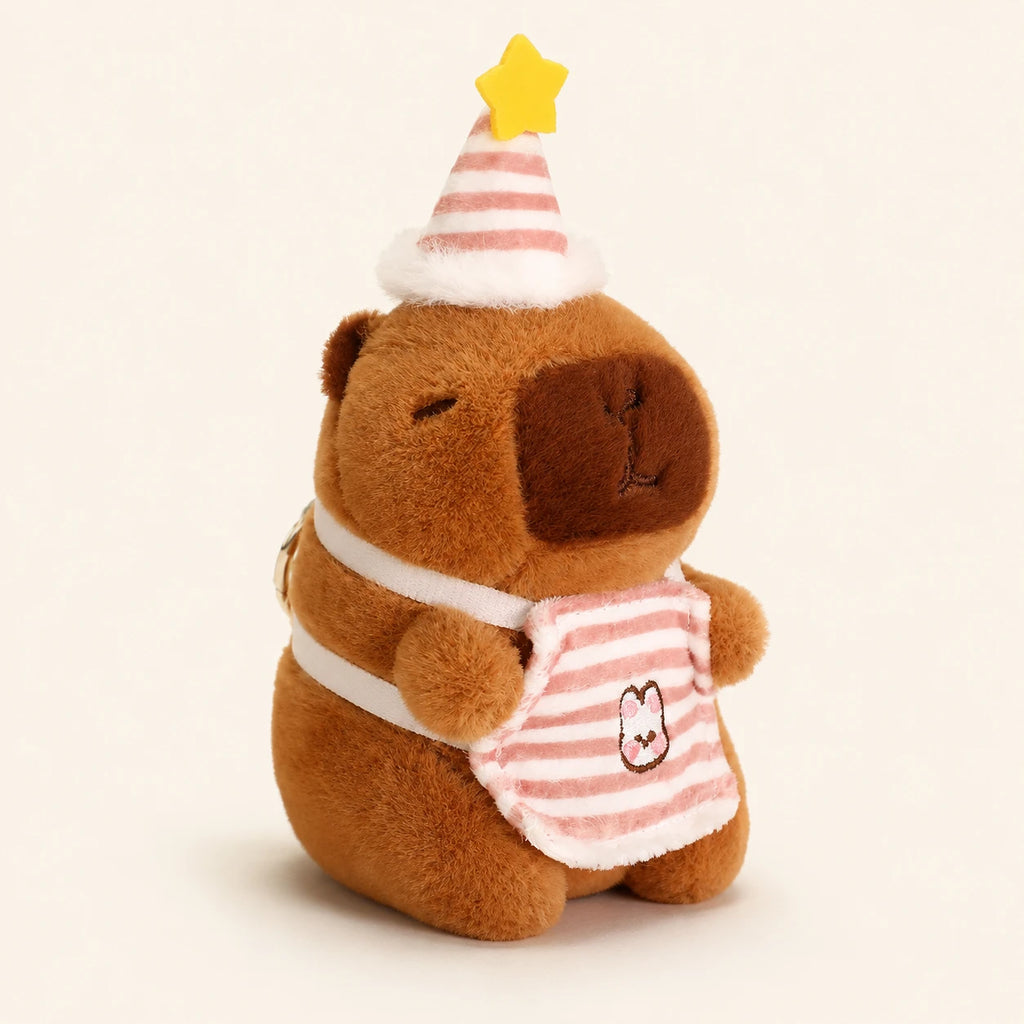 Peluche capybara avec chapeau de fete etoile, environ 12 cm, fond ivoire