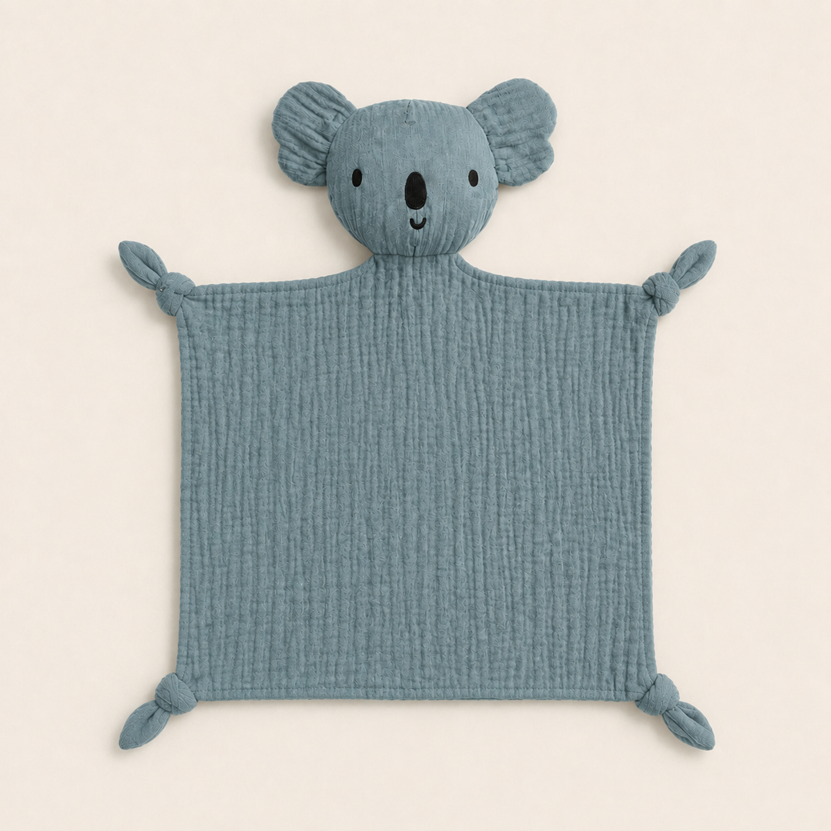 Doudou personnalisé koala bleu grisé en gaze de coton, quatre coins noués, vue de face sur fond ivoire