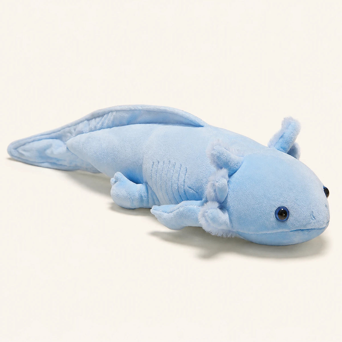 Peluche axolotl bleu, vue principale de profil sur fond ivoire