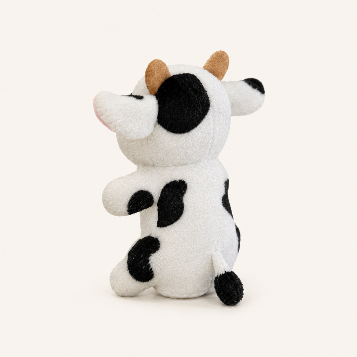 Marionnette à doigt vache peluche vue de trois quarts