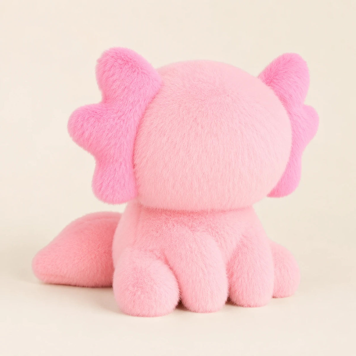 Peluche axolotl rose vue de trois-quarts arrière montrant la queue