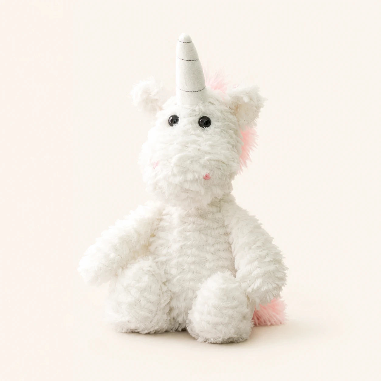 Peluche licorne blanche à longues pattes, vue de face sur fond ivoire