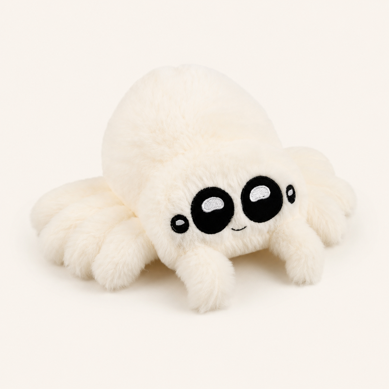 Peluche araignée blanche aux grands yeux, vue principale sur fond ivoire