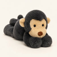 Peluche singe noire 40 cm couchee, vue principale sur fond ivoire