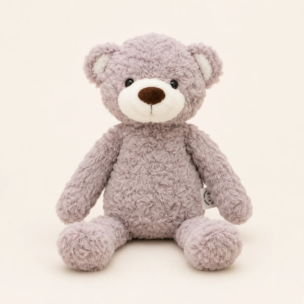 Ours en peluche gris-taupe assis, vue de face sur fond ivoire