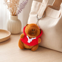 Peluche porte-clés capybara accrochée à un sac tote, ambiance cosy