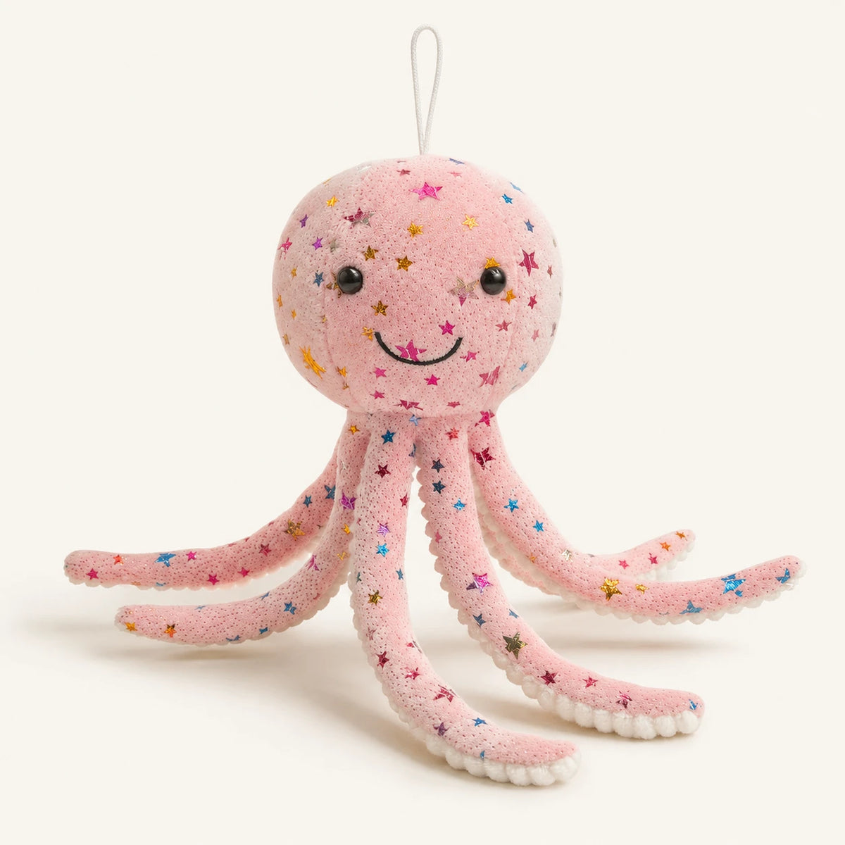 Peluche pieuvre rose à étoiles multicolores, vue de face sur fond ivoire