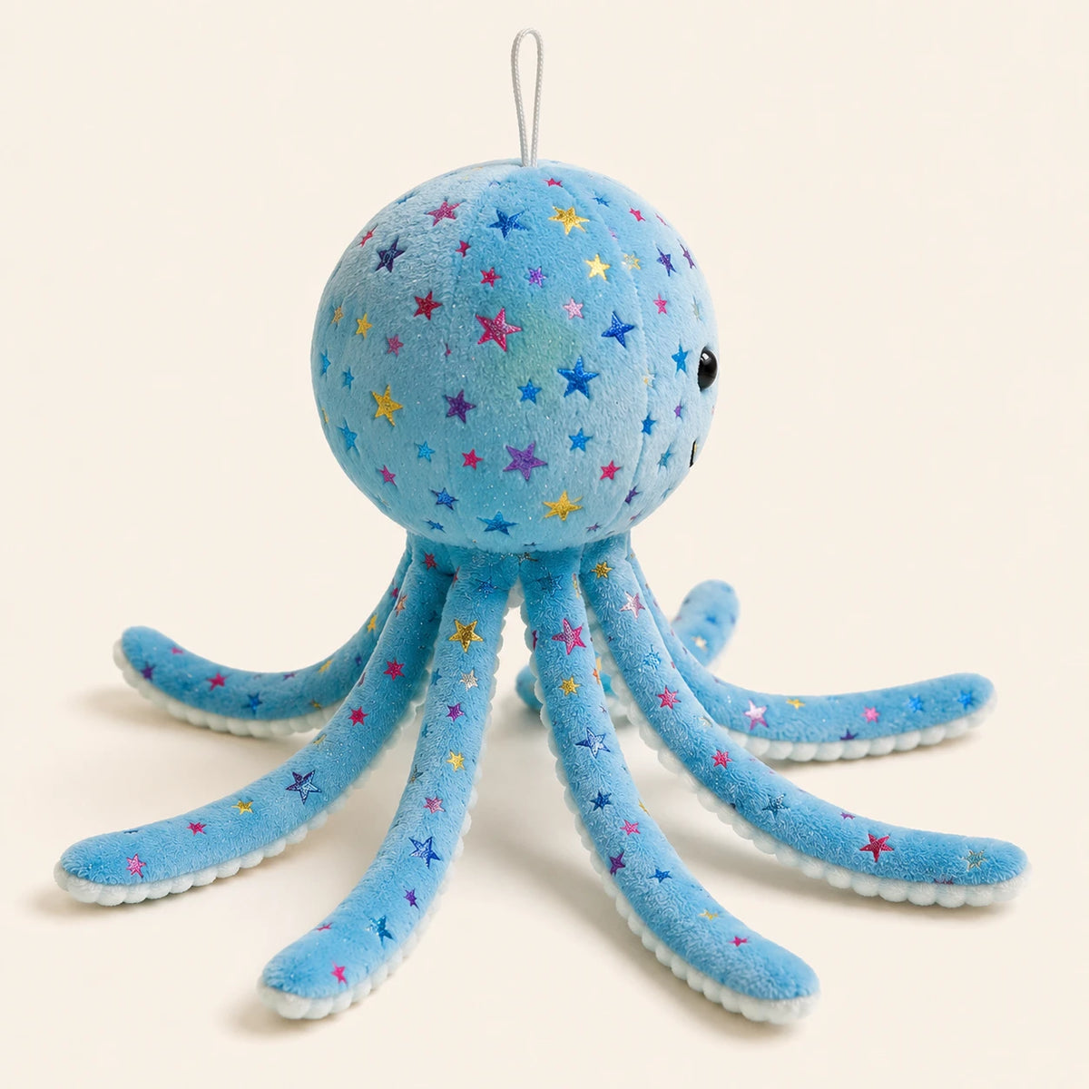 Peluche pieuvre bleue, vue de trois-quarts, fond ivoire
