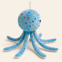 Peluche pieuvre bleue, vue de trois-quarts, fond ivoire