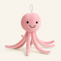 Peluche pieuvre rose, vue de face, fond ivoire