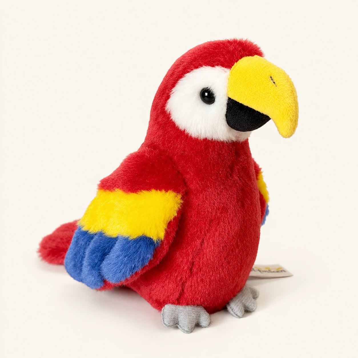 Peluche perroquet ara rouge a epaule aimantee, vue principale sur fond ivoire