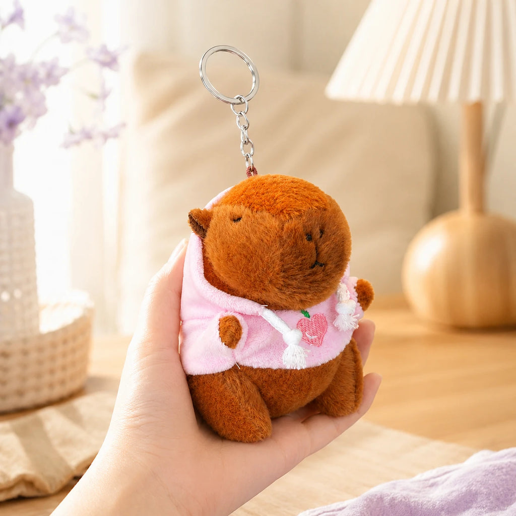 Peluche porte-clés capybara tenue en main, ambiance cosy