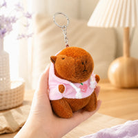 Peluche porte-clés capybara tenue en main, ambiance cosy