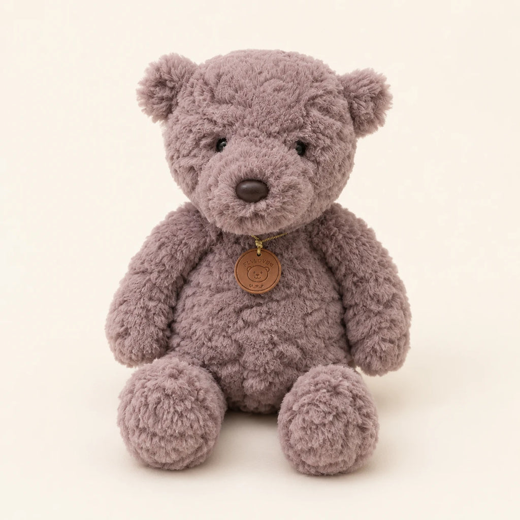 Peluche ours gris assise, vue de face sur fond ivoire
