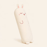 Coussin peluche lapin vu de trois-quarts sur fond ivoire