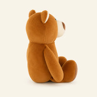 Peluche ours brun vue de profil, fond ivoire