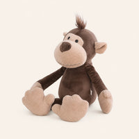 Peluche singe vue de trois-quarts sur fond ivoire