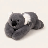 Peluche koala grise, vue de côté, fond ivoire