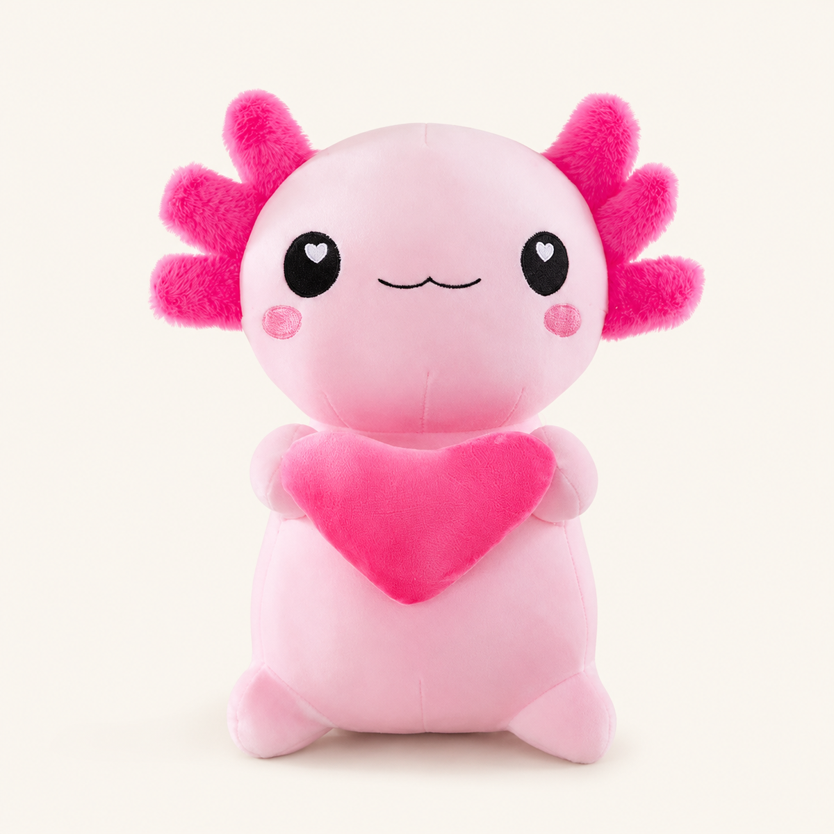 Peluche axolotl rose avec cœur, vue principale sur fond ivoire
