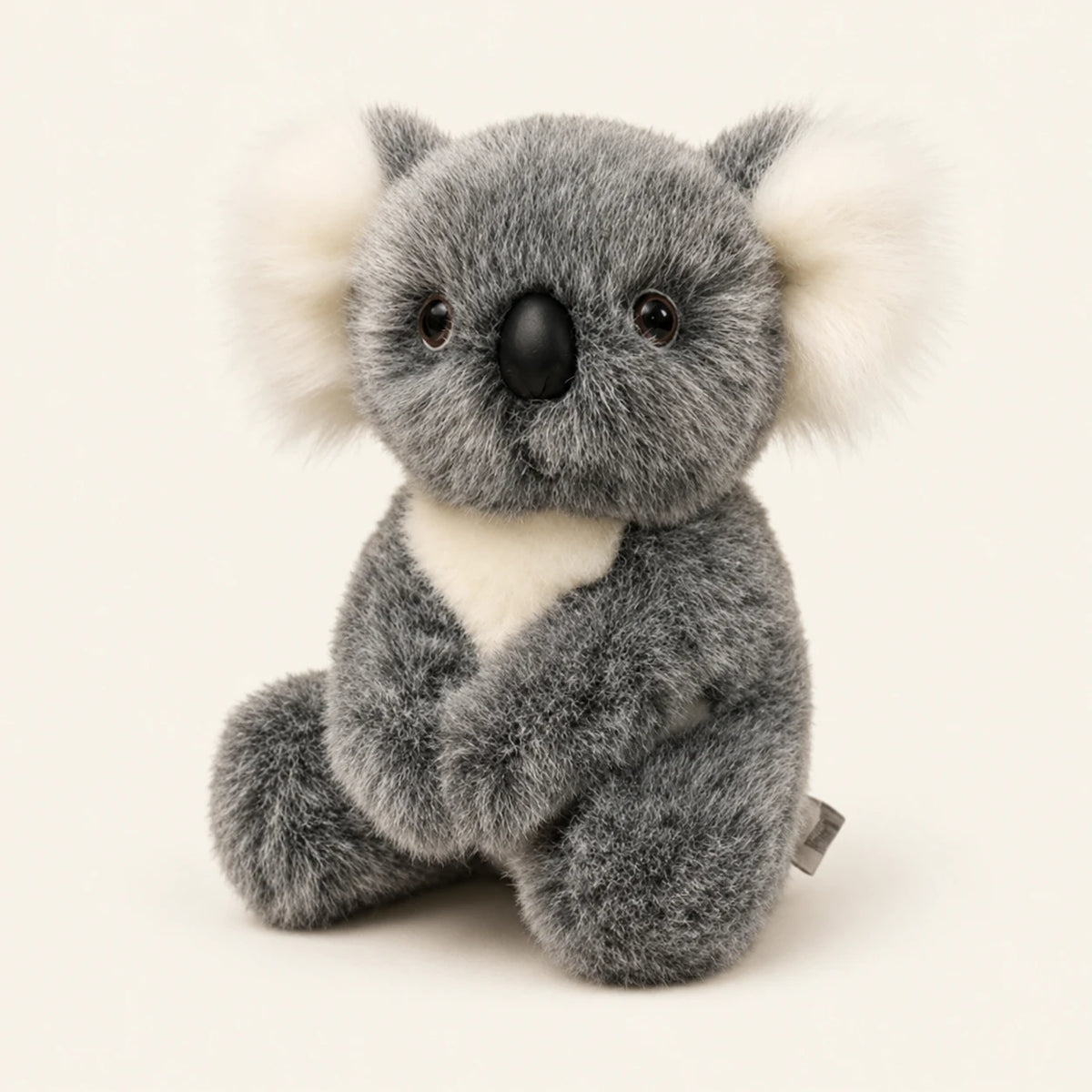 Peluche koala grise assise, vue principale sur fond ivoire