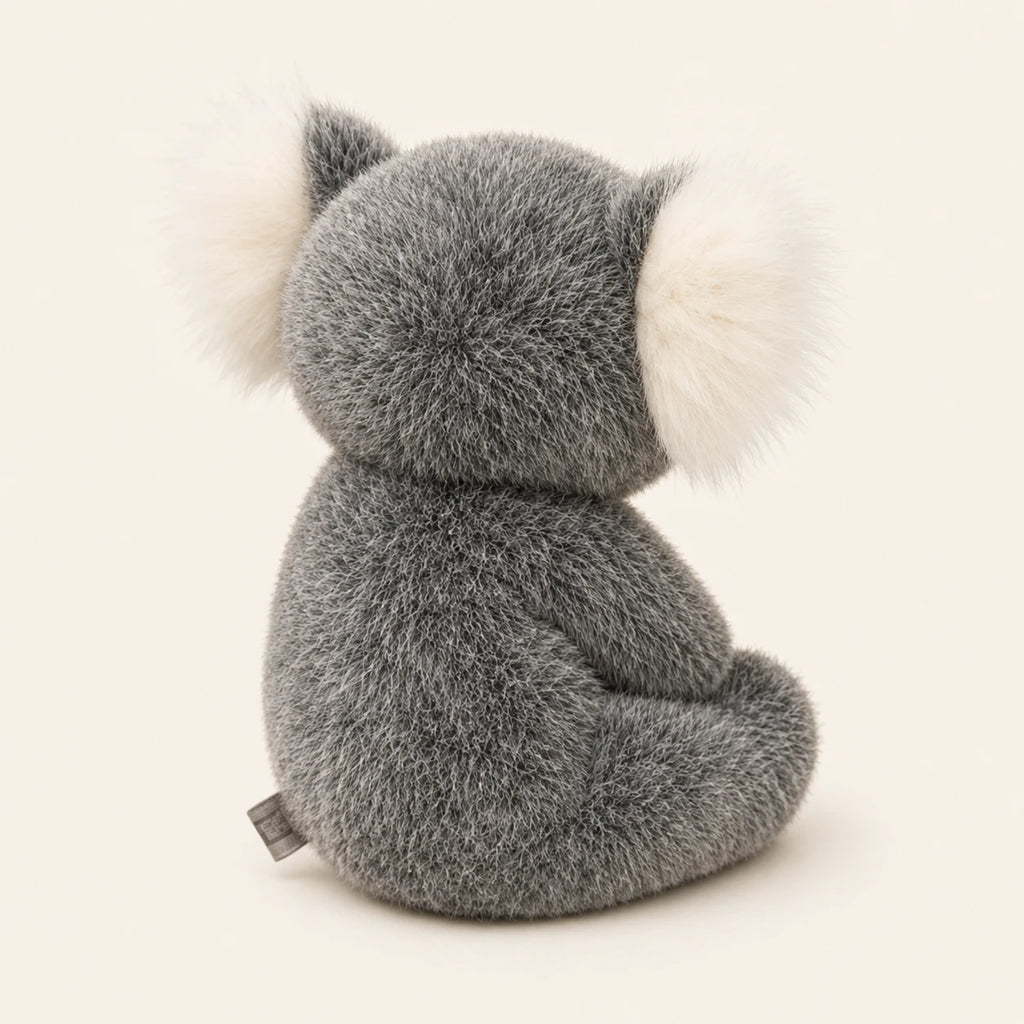 Peluche koala grise vue de dos sur fond ivoire