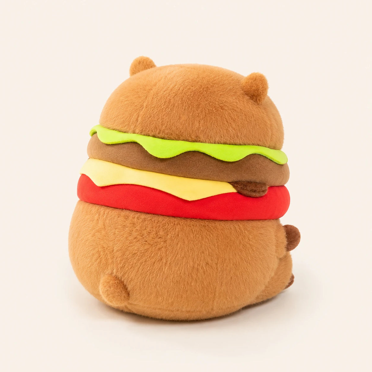 Peluche capybara hamburger, vue de dos, fond ivoire