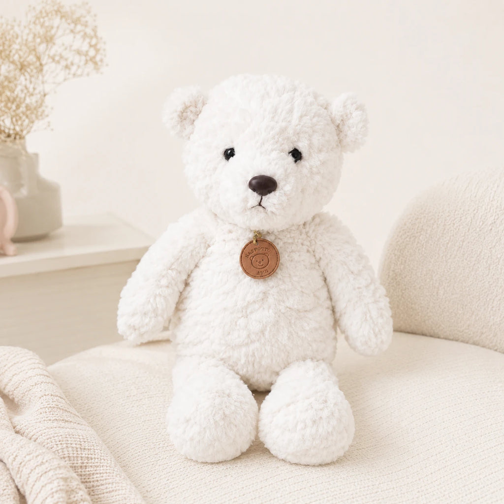 Peluche ours blanc longues pattes 50 cm installée dans un fauteuil
