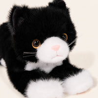 Peluche chat realiste noir et blanc, gros plan detail du visage