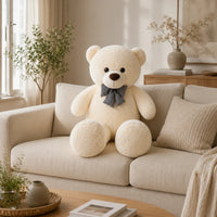 Grand ours en peluche blanc 105 cm pose sur un canape creme