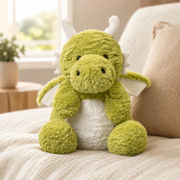 Peluche dragon vert en situation dans un interieur